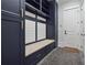 The mudroom features custom built-in cabinets, bench seating, and easy access to the exterior at 10745 Shallowford Rd, Roswell, GA 30075