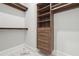 Custom walk-in closet featuring built-in shelving and drawers for optimal storage solutions and a refined design at 10745 Shallowford Rd, Roswell, GA 30075