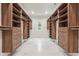 Extensive walk-in closet with custom wood shelving and drawer systems for optimized storage at 10745 Shallowford Rd, Roswell, GA 30075