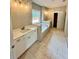 Bathroom featuring double vanity, soaking tub, tile floors, and modern fixtures at 1273 Jersey Social Circle Rd, Covington, GA 30014