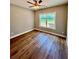 A bedroom featuring hardwood floors, a ceiling fan, and a bright window with a nature view at 1273 Jersey Social Circle Rd, Covington, GA 30014