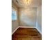 A cozy bedroom with hardwood floors and natural light coming through the window at 1273 Jersey Social Circle Rd, Covington, GA 30014