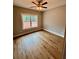 A bedroom featuring hardwood floors, a ceiling fan, and a bright window with a view at 1273 Jersey Social Circle Rd, Covington, GA 30014
