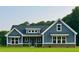 Charming blue home with white trim, stone accents, and a well-manicured lawn at 1273 Jersey Social Circle Rd, Covington, GA 30014