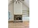 Living room featuring stone fireplace, hardwood floors, built-in shelving and cabinets at 1273 Jersey Social Circle Rd, Covington, GA 30014