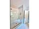 Tiled walk-in shower featuring tiled floors, tiled walls, built-in shelves and glass door at 1273 Jersey Social Circle Rd, Covington, GA 30014