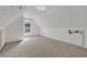 Bright attic space featuring neutral carpet, window and bonus storage area at 3012 Keeneland Blvd, Mcdonough, GA 30252