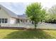 Backyard showcasing a covered patio, rocking chairs, and a decorative white fence at 3012 Keeneland Blvd, Mcdonough, GA 30252