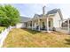 Spacious backyard with a covered porch, rocking chairs, and a charming white fence at 3012 Keeneland Blvd, Mcdonough, GA 30252