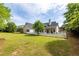 Large backyard with a white picket fence and mature trees at 3012 Keeneland Blvd, Mcdonough, GA 30252