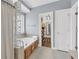 Bright bathroom with a soaking tub, glass block partition, and access to a walk-in closet at 3012 Keeneland Blvd, Mcdonough, GA 30252