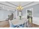 Elegant dining room featuring wainscoting, hardwood floors, a decorative chandelier and ample natural light at 3012 Keeneland Blvd, Mcdonough, GA 30252