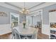 Bright dining room with hardwood floors, classic wainscoting, chandelier, and ample natural light at 3012 Keeneland Blvd, Mcdonough, GA 30252