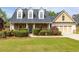 Charming, two-story home boasts stone accents, a well-manicured lawn, and a cozy, inviting front porch at 3012 Keeneland Blvd, Mcdonough, GA 30252