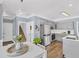 Bright kitchen features stainless appliances, a center island and leads to the staircase at 3012 Keeneland Blvd, Mcdonough, GA 30252