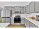 Modern kitchen is equipped with stainless appliances, gray cabinetry, and stylish countertops at 3012 Keeneland Blvd, Mcdonough, GA 30252