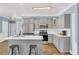 Well-lit kitchen has stainless appliances, gray cabinets, and a functional center island at 3012 Keeneland Blvd, Mcdonough, GA 30252
