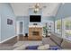Comfortable living room features a stone fireplace, vaulted ceilings, hardwood floors, and plenty of natural light at 3012 Keeneland Blvd, Mcdonough, GA 30252