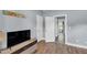 Comfortable living room with hardwood floors and an entertainment center; connecting hallway is visible at 3012 Keeneland Blvd, Mcdonough, GA 30252