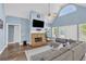 Inviting living room with a stone fireplace, vaulted ceilings, hardwood floors, and abundant natural light at 3012 Keeneland Blvd, Mcdonough, GA 30252