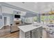 Stylish living room with vaulted ceilings, a fireplace, and seamlessly connecting kitchen space at 3012 Keeneland Blvd, Mcdonough, GA 30252