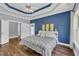 Stylish main bedroom with tray ceiling, backyard views, and wood floors offers a peaceful retreat at 3012 Keeneland Blvd, Mcdonough, GA 30252