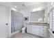 Bathroom with granite counters, tile floors, large vanity, and shower with a gray and white shower curtain at 785 Wilson Nw Rd, Atlanta, GA 30318