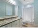 Well-lit bathroom featuring granite countertops, a large mirror, and decorative wallpaper at 785 Wilson Nw Rd, Atlanta, GA 30318