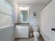 Bathroom with a toilet, shower, white vanity, light patterned wallpaper, and granite counters at 785 Wilson Nw Rd, Atlanta, GA 30318