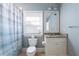 Bathroom featuring a white vanity with granite counters, a mirror, and toilet with gray-blue walls at 785 Wilson Nw Rd, Atlanta, GA 30318