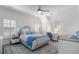 Bedroom featuring a patterned rug, ceiling fan, lots of light, and blue accents at 785 Wilson Nw Rd, Atlanta, GA 30318