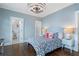 Stylish bedroom featuring an elegant light fixture, blue walls, and a bedroom next door at 785 Wilson Nw Rd, Atlanta, GA 30318