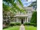 Charming two-story home with shake siding, manicured landscaping, and a covered front porch at 785 Wilson Nw Rd, Atlanta, GA 30318