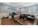 Spacious home gym features a rowing machine, stationary bike, TV, and cozy leather couch at 785 Wilson Nw Rd, Atlanta, GA 30318