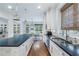 Bright kitchen features stainless steel appliances, an island with a dark countertop, and wooden floors at 785 Wilson Nw Rd, Atlanta, GA 30318