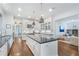 Bright kitchen boasts an island with dark countertops, white cabinets, stainless steel appliances, and hardwood floors at 785 Wilson Nw Rd, Atlanta, GA 30318