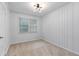 This bedroom features neutral carpet, bright white walls, and simple yet modern light fixture at 2599 E Tupelo Se St, Atlanta, GA 30317