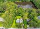 Aerial shot showcasing the home's location surrounded by lush greenery and a serene lake at 2736 Whisper Trl, Douglasville, GA 30135