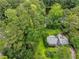 Aerial view of a home with lush green trees and a nearby lake at 2736 Whisper Trl, Douglasville, GA 30135