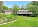 Charming home with a deck overlooking a lush green backyard with mature trees at 2736 Whisper Trl, Douglasville, GA 30135