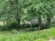 View of the serene backyard with a pond in the distance at 2736 Whisper Trl, Douglasville, GA 30135