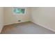 Bright bedroom with a window offering natural light and neutral carpet flooring at 2736 Whisper Trl, Douglasville, GA 30135