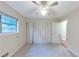 Bedroom with a ceiling fan, closet with folding doors, and a window at 2736 Whisper Trl, Douglasville, GA 30135