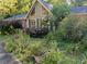 Charming home exterior featuring an A-frame design and lush landscaping at 2736 Whisper Trl, Douglasville, GA 30135