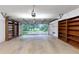 View of spacious garage with built-in shelving, and open garage door at 2736 Whisper Trl, Douglasville, GA 30135