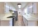 Galley kitchen featuring white cabinets, stainless steel appliances, and tile flooring at 2736 Whisper Trl, Douglasville, GA 30135