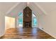 Warm and inviting living room with exposed beams, a brick fireplace, and wood flooring at 2736 Whisper Trl, Douglasville, GA 30135