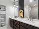 Bathroom features a double sink vanity, a large mirror and marble tiled walk-in shower at 3484 Orchard St, Atlanta, GA 30354