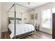This bedroom features a silver canopy bed frame, side table and hard wood flooring at 3484 Orchard St, Atlanta, GA 30354