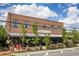 Exterior view of a vintage brick Corner Tavern, with outdoor seating and lush greenery at 3484 Orchard St, Atlanta, GA 30354